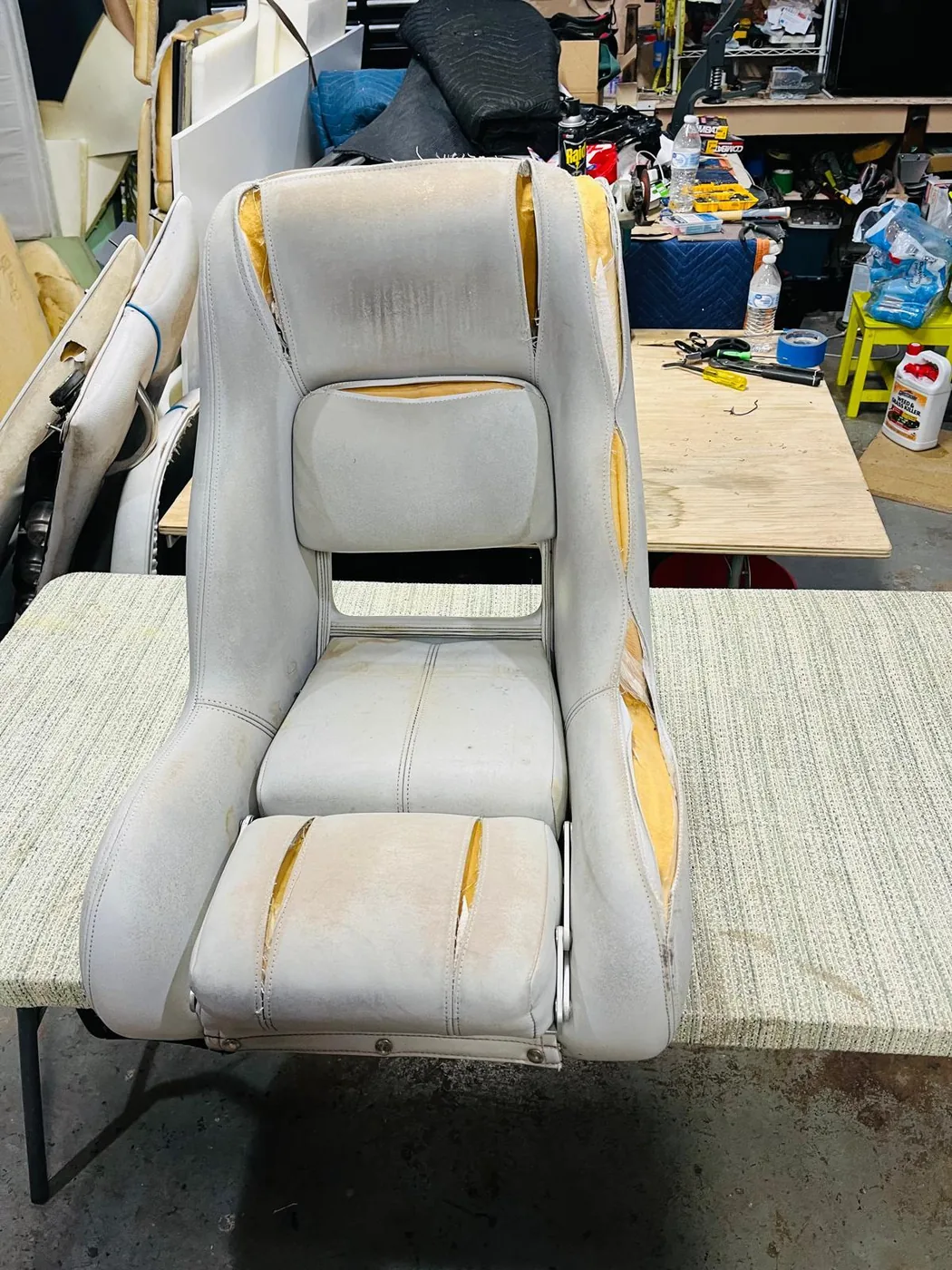 Worn boat seat before upholstery restoration
